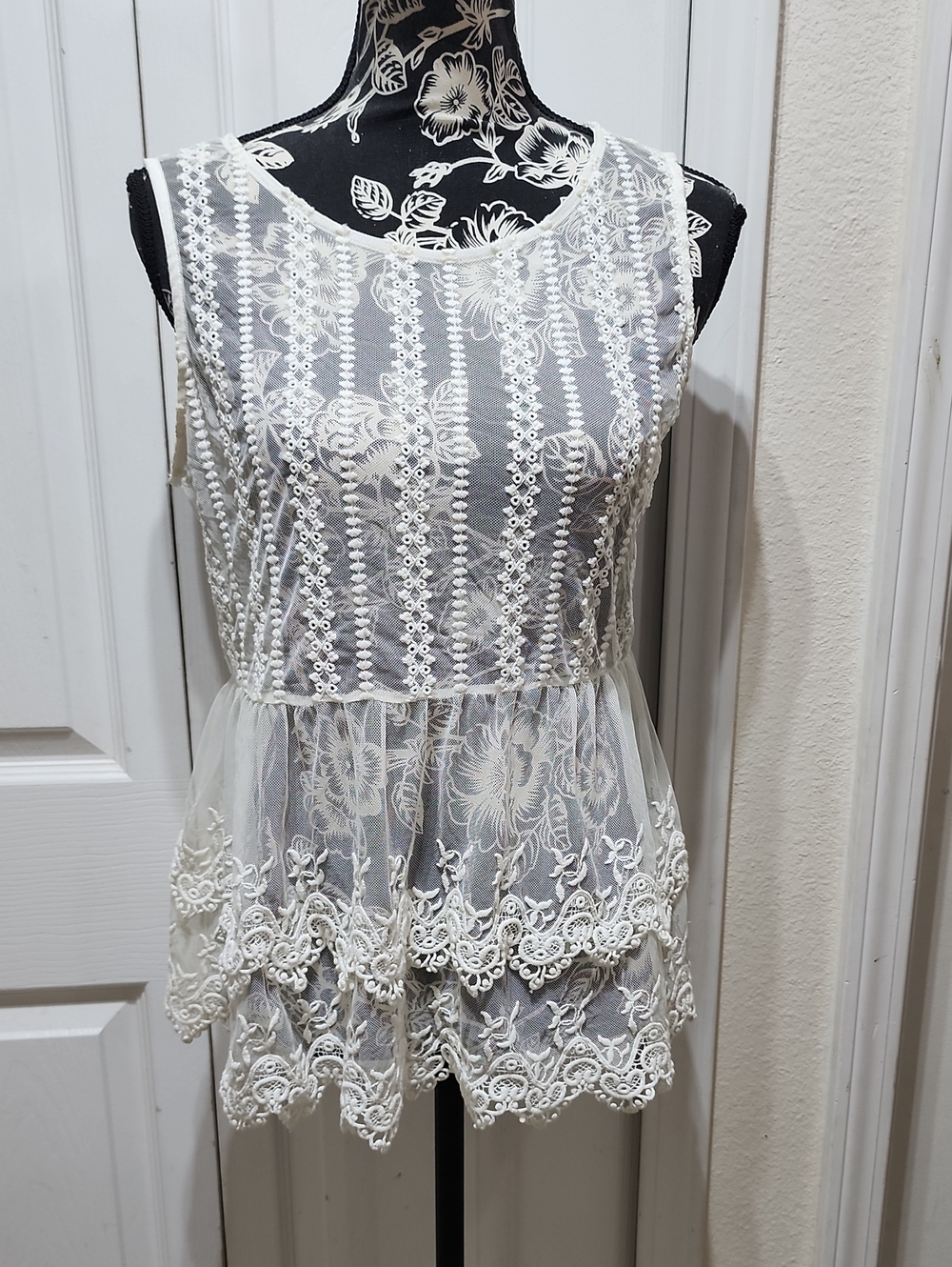 Lace Overlay Sleeveless Peplum Top in White